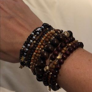Stack of gold and wood beaded bracelets